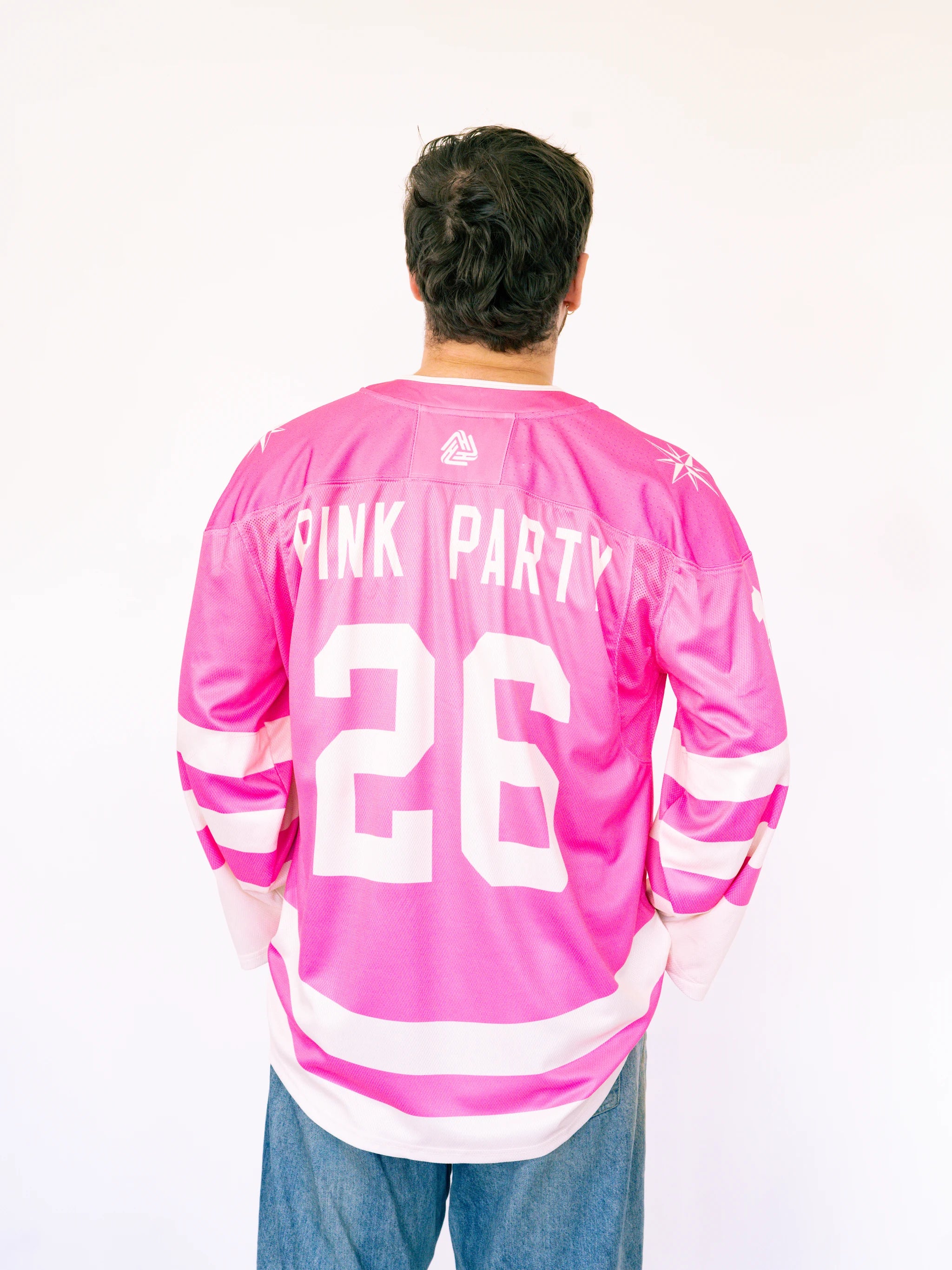 Person wearing a pink sports jersey with 'Pink Party' and number '26' on a white background