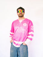 Person wearing a pink jersey with text and colorful sunglasses on a white background