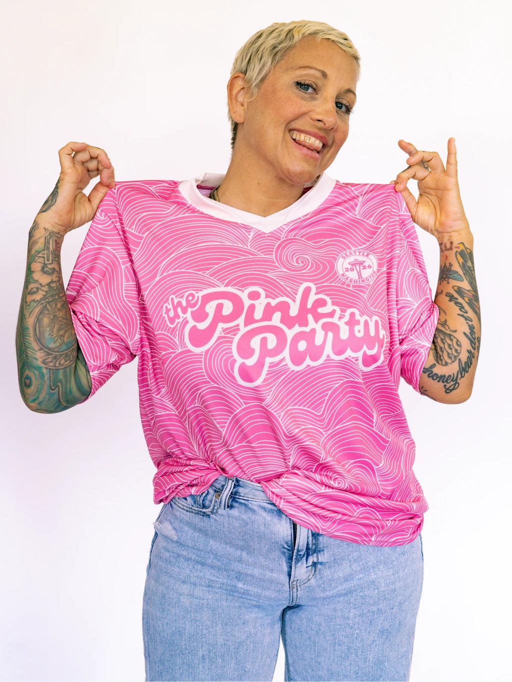 Person wearing a pink 'The Pink Party' shirt with a white background
