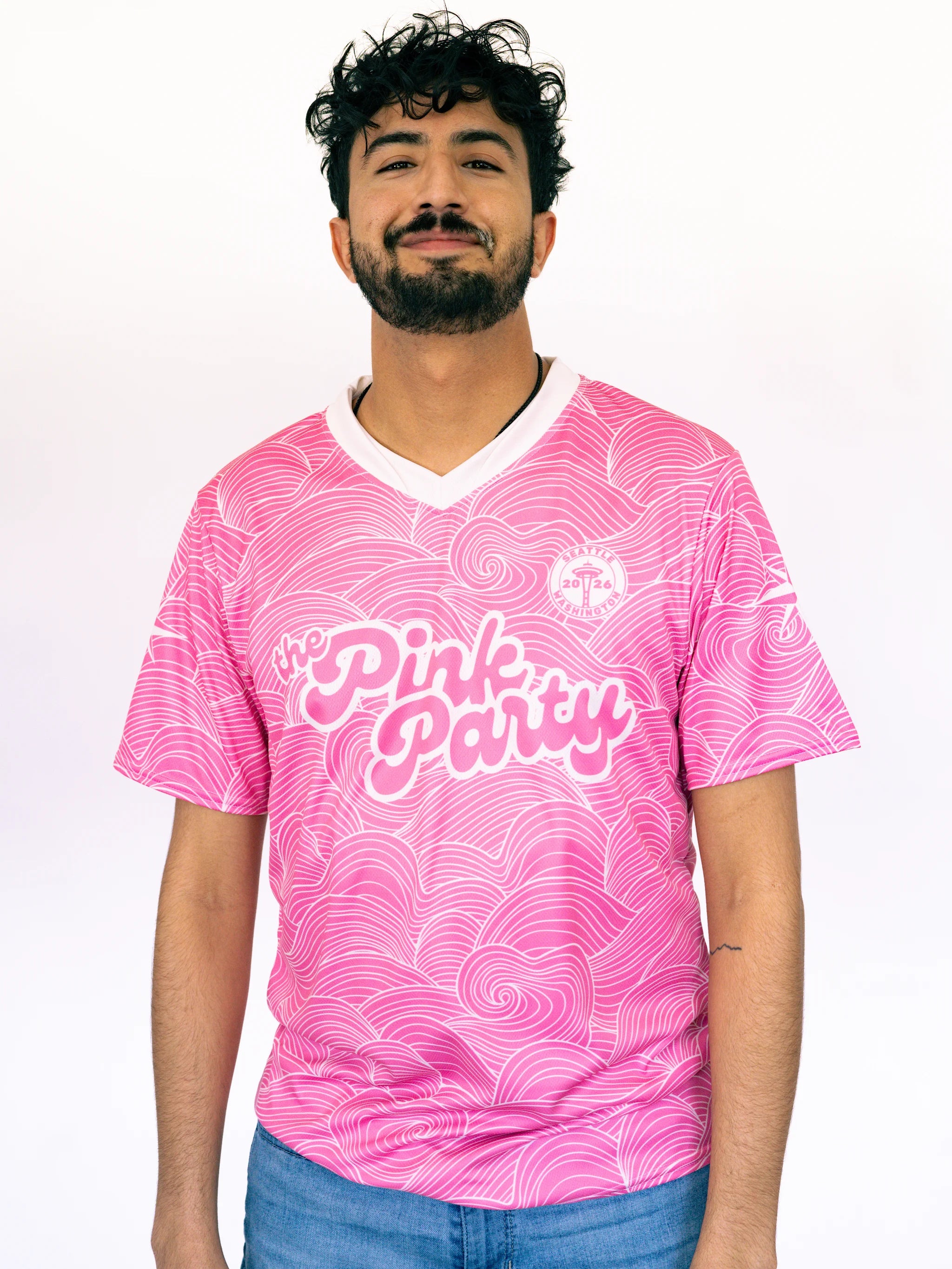 Man wearing a pink 'Pink Party' t-shirt with a white background