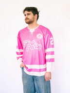Man wearing a pink hockey jersey with 'Pink Party' text on a white background