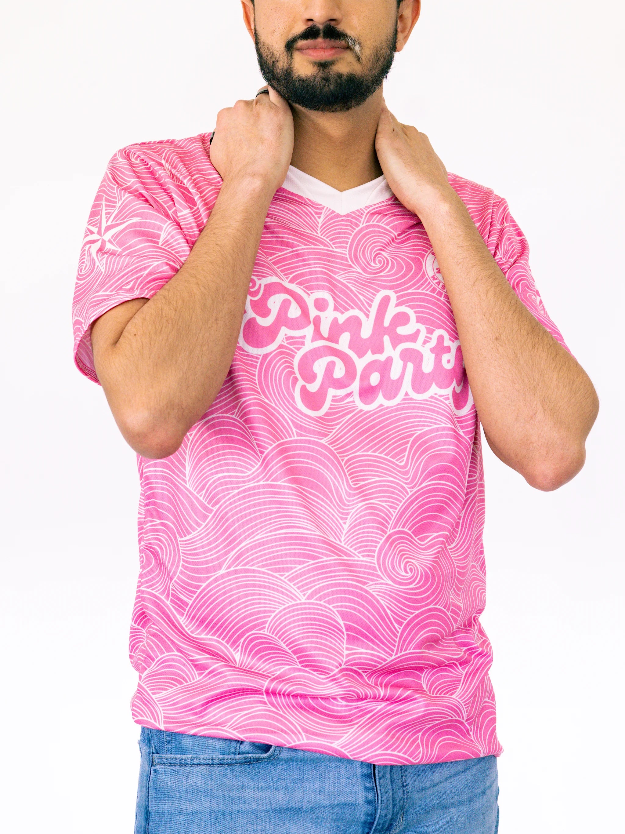 Person wearing a pink t-shirt with white text and patterns on a white background