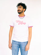 Man wearing a white t-shirt with pink text on a plain background