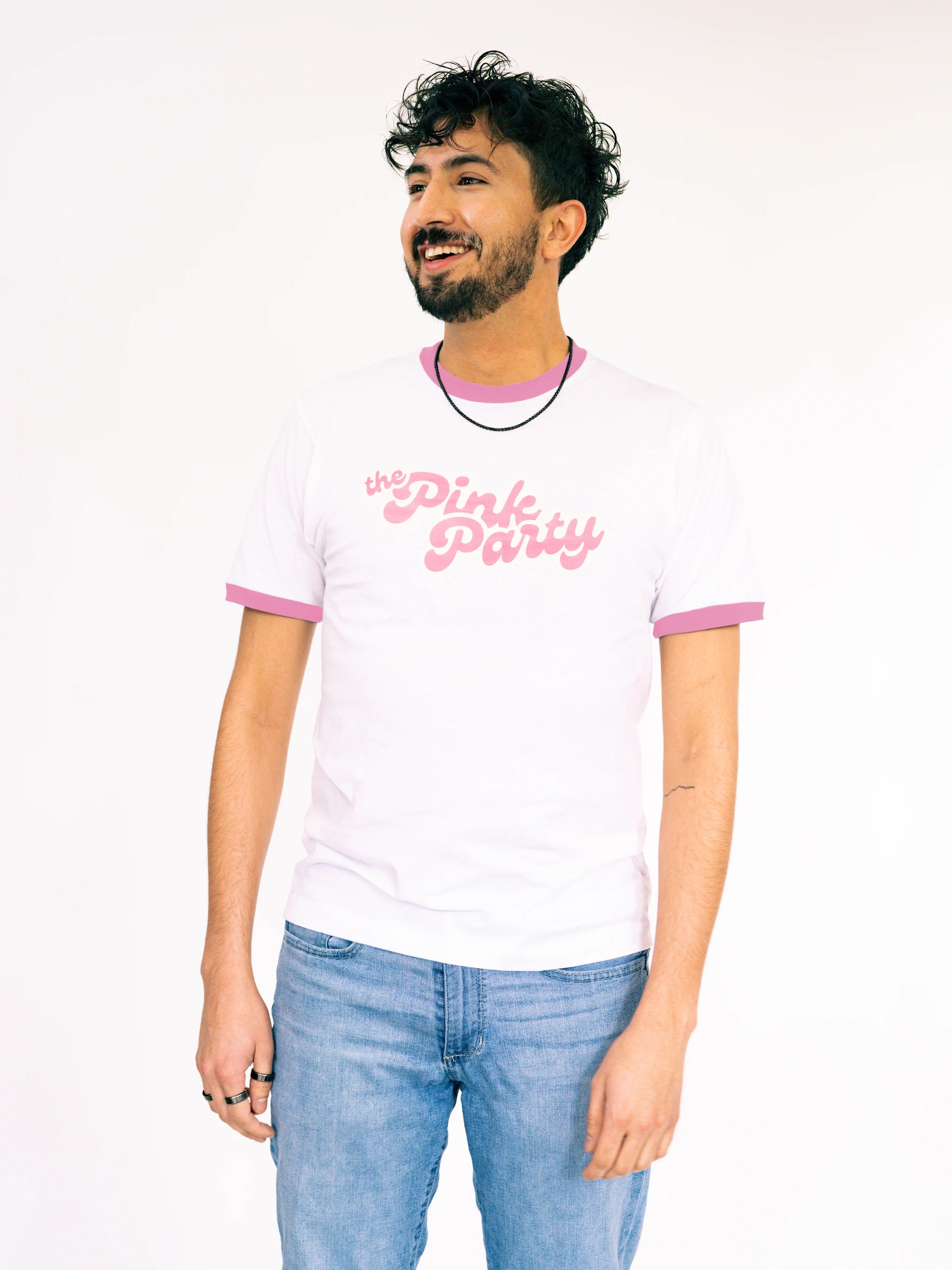 Man wearing a white t-shirt with pink text on a plain background
