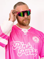 Person wearing a pink hockey jersey with 'the Pink Party' text, holding colorful sunglasses.