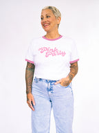 Person wearing a white t-shirt with pink trim and 'Pink Party' text, paired with light blue jeans on a white background.